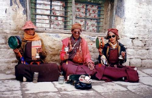 Three monks seeking alms in Lhasa, Tibet in 1993. from wikipedia, photo by john hill